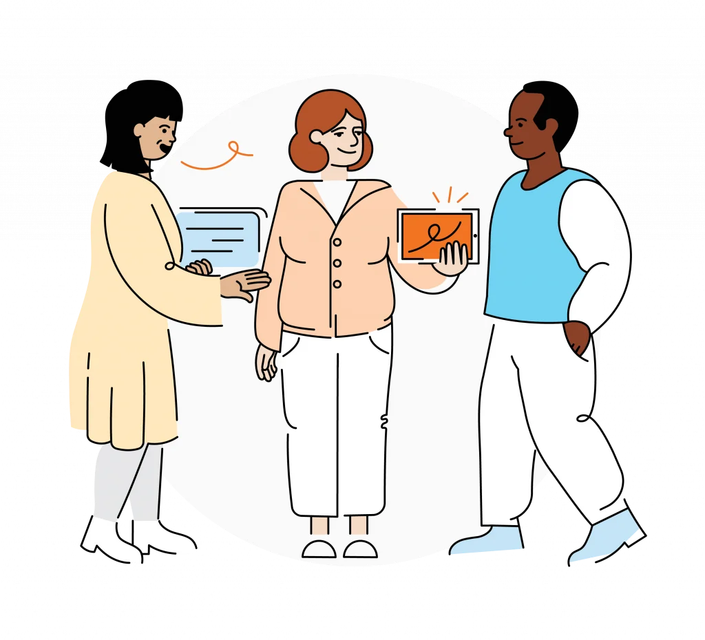 Three people stand together, one holding a laptop, another holding a tablet, and the third person standing in the center, all appearing to engage in conversation.